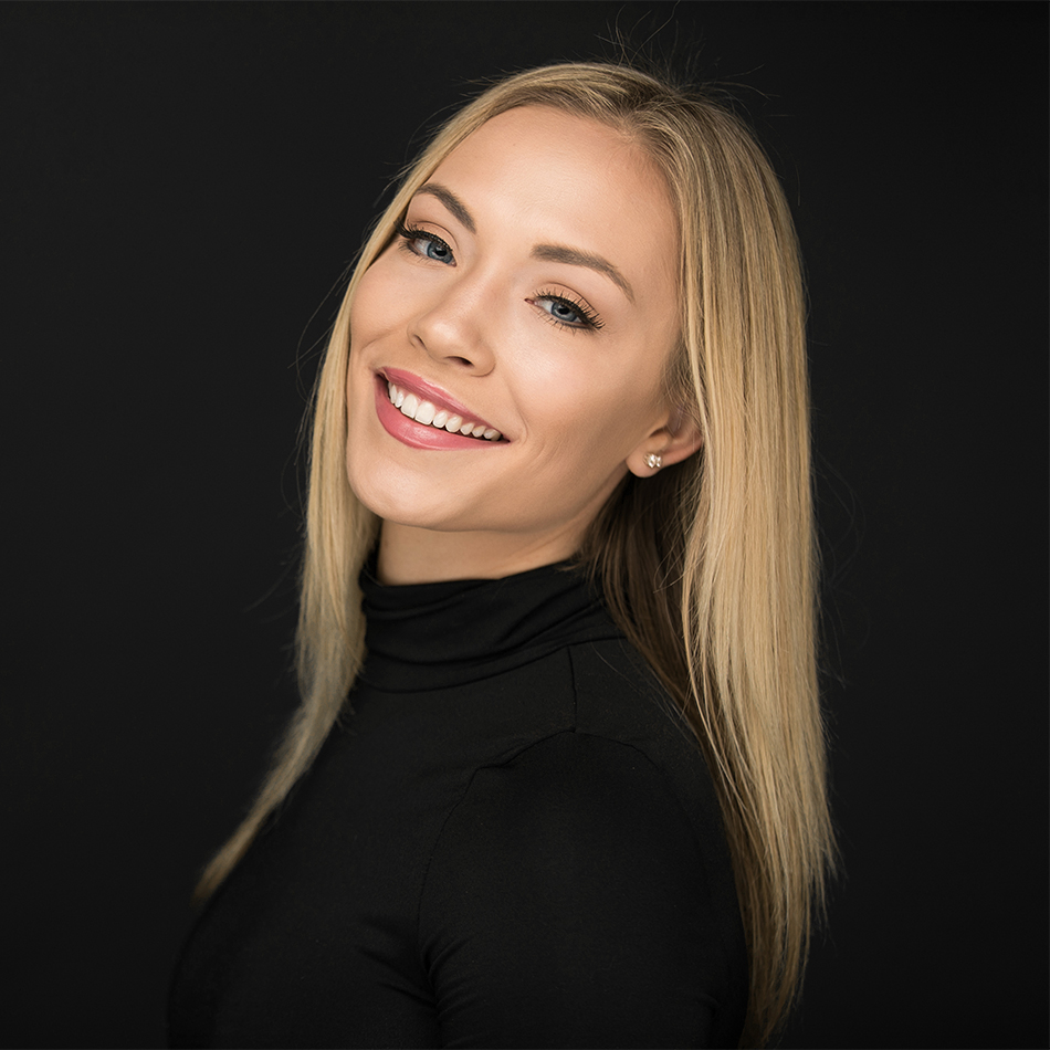 Beautiful portrait of smiling blond woman on a black background